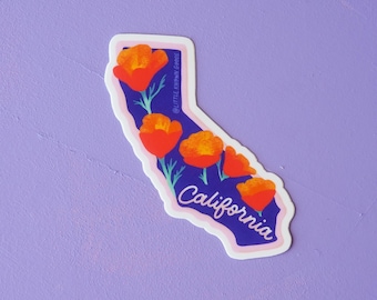 May include: A sticker in the shape of California, featuring orange poppies on a dark blue background. The word "California" is written in cursive. The sticker has a white border and is on a purple background.