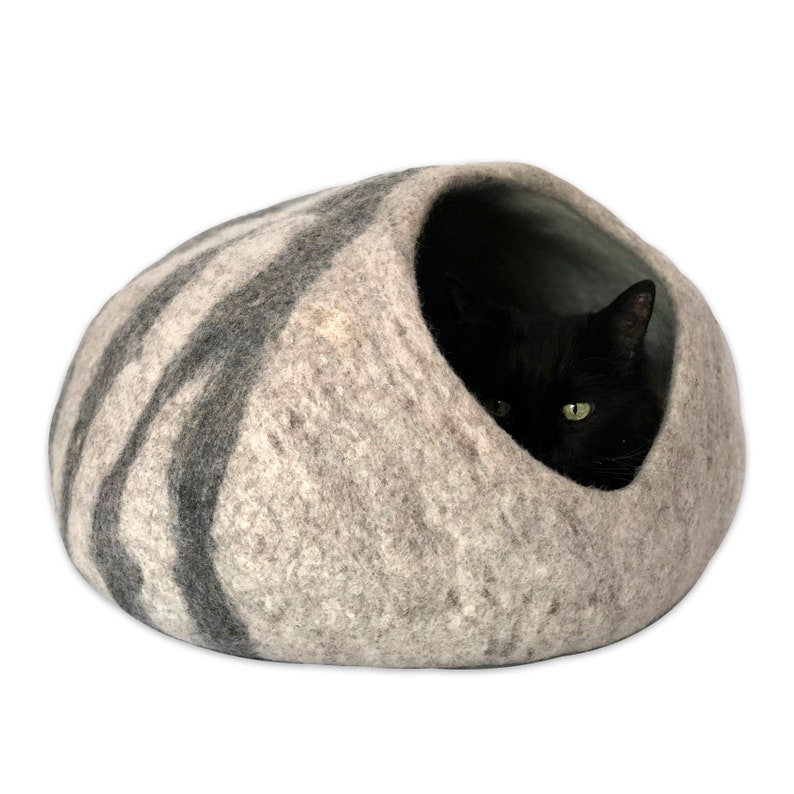 Black cat in wool cat cave