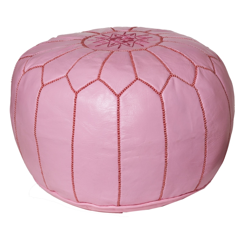 May include: A pink leather pouf with a star-shaped design in the center. The pouf has a stitched pattern around the edges.