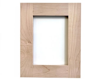 May include: A light wood cabinet door with a raised panel design.