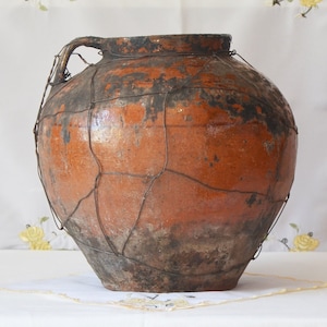 Wabi sabi pottery indoor planter. Old black clay pot. Antique terracotta vessel.