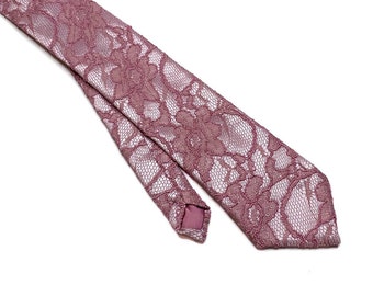May include: A pink lace tie with a floral pattern.