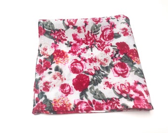 May include: A white fabric handkerchief with a pink and green floral pattern.