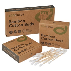 May include: Three boxes of bamboo cotton buds. The boxes are made of brown cardboard and have a green logo with the text "ecoslurps". The boxes are labeled "Bamboo Cotton Buds" and have a variety of certifications, including "100% Biodegradable" and "Premium Organic Biodegradable Compostable".