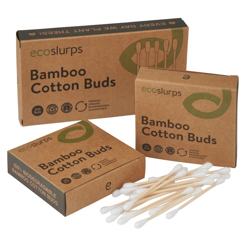May include: Three boxes of bamboo cotton buds. The boxes are made of brown cardboard and have a green logo with the text "ecoslurps". The boxes are labeled "Bamboo Cotton Buds" and have a variety of certifications, including "100% Biodegradable" and "Premium Organic Biodegradable Compostable".