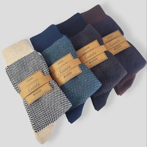 May include: Four pairs of socks in different colours, each with a checkered pattern. The socks are packaged with a brown label that says "Saints Combed Cotton Saints".