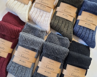 May include: Assortment of wool socks in various colors, including gray, black, green, and burgundy. Each pair has a brown label with the text "Saints Lamb's Wool" and a logo.