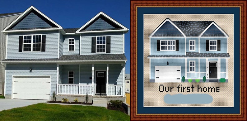 May include: A cross-stitch pattern of a two-storey house with a garage, porch, and landscaping. The text "Our first home" is below the house. The pattern is framed in a brown wood frame.