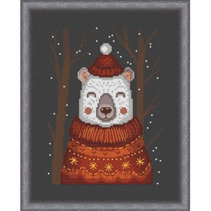 May include: A white polar bear wearing a red and orange knitted sweater and a red Santa hat with a white pom-pom. The bear is standing in front of a dark gray background with white snowflakes.