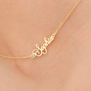 May include: Gold anklet with the name "Sophia" written in cursive.