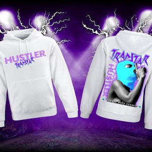 May include: White hoodie with a purple and blue graphic print on the front that says "Hustler Trapstar" and a purple and blue graphic print on the back that says "Hustler Trapstar" with a person wearing a blue ski mask holding a microphone.