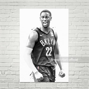 May include: Black and white illustration of a basketball player wearing a black jersey with the word "BKLYN" and the number "22" on the front. The player is wearing a white arm band and has a determined expression on his face.