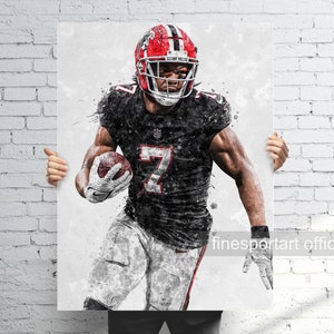 May include: A watercolor-style illustration of a football player wearing a black and red uniform with the number 7 on the front. The player is holding a football and has a determined expression on his face. The background is white with a splatter effect.