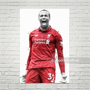 Könnte beinhalten: Ein Schwarzweißfoto eines Fußballspielers, der ein rotes Trikot mit dem Text "Standard Chartered" und dem Logo des FC Liverpool trägt. Der Spieler trägt rote Shorts mit der Nummer 32. Der Spieler schreit und hat einen entschlossenen Gesichtsausdruck.