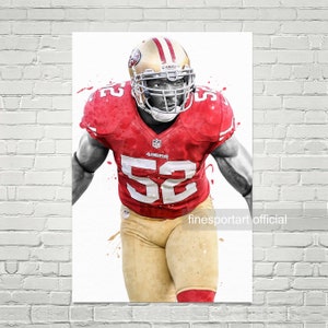 May include: A watercolor illustration of a football player wearing a red and gold uniform with the number 52 on the front. The player is wearing a helmet and has a determined expression on his face. The background is white with splashes of red and gold paint.