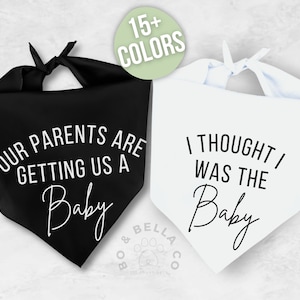 May include: Two triangular pet bandanas with tie closures. The black bandana features white text reading "OUR PARENTS ARE GETTING US A BABY". The white bandana features black text reading "I THOUGHT I WAS THE BABY". A green circle indicates 15+ colors.