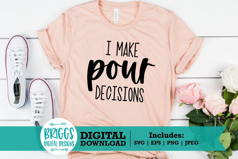 May include: A pink t-shirt with the text "I make pour decisions" in black lettering. The shirt is on a white wooden background with white sneakers and pink flowers.