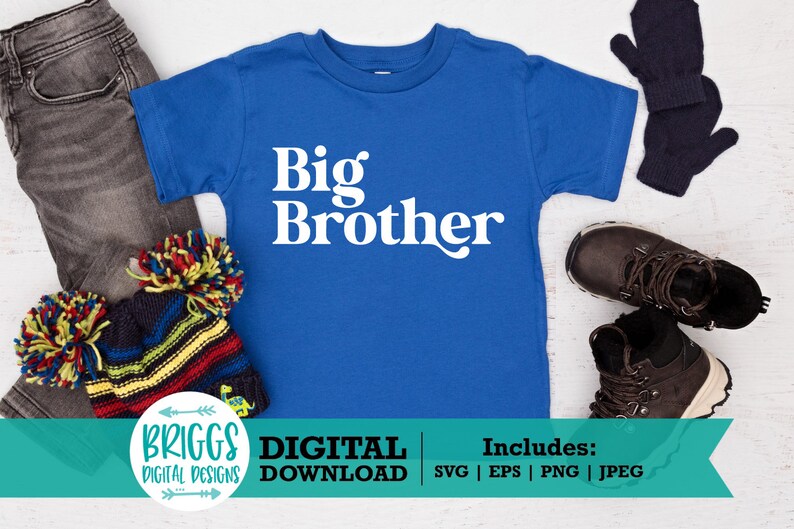 May include: A blue t-shirt with the text "Big Brother" in white. The shirt is on a white wooden surface with a hat, jeans, and gloves around it.