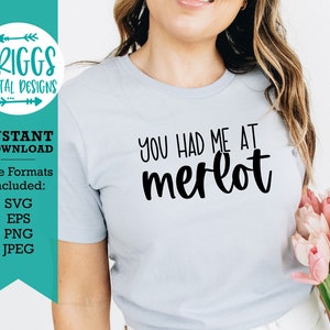May include: A light blue t-shirt with the text "You had me at merlot" in black script font.