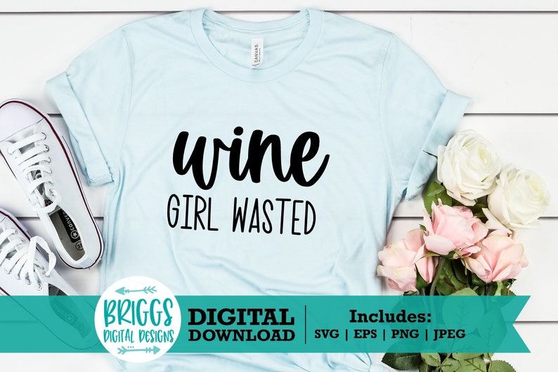 May include: A light blue t-shirt with the text "wine girl wasted" in black lettering. The shirt is laid flat on a white wooden surface with a bouquet of white and pink roses and a pair of white sneakers.