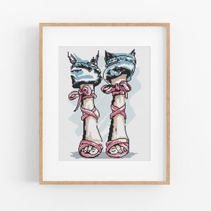 May include: A pair of pink high-heeled sandals with pink ribbon laces. The sandals are worn with blue denim jeans.