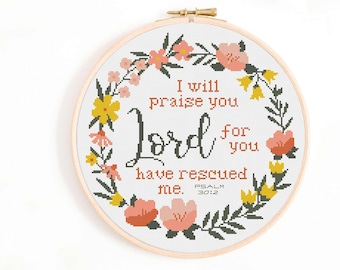 May include: Cross stitch pattern featuring a floral wreath and the text "I will praise you Lord for you have rescued me. Psalm 30:2".