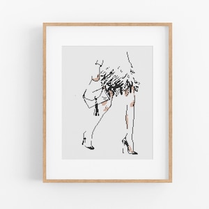 May include: A black and white line drawing of a person wearing a short, fringed skirt and high heels. The person is standing with one leg slightly bent and the other leg straight.