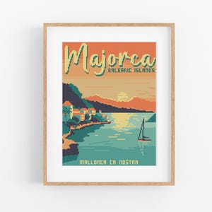 May include: A framed pixel art print featuring a coastal scene of Majorca, Balearic Islands. The artwork depicts a sunset over the sea with a sailboat, buildings, and the text "Majorca" and "Mallorca Ca Nostra". The color palette includes orange, teal, and beige.