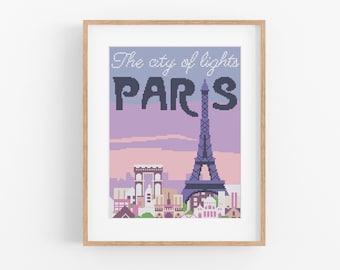 May include: A cross-stitch pattern of the Eiffel Tower in Paris, France. The pattern is framed in a light wood frame. The text "The city of lights PARIS" is above the Eiffel Tower.