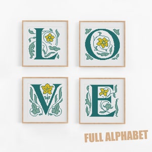 May include: Four framed cross-stitch designs of the letters L, O, V, and E in teal with yellow flowers and green foliage. The text "FULL ALPHABET" is below the frames.