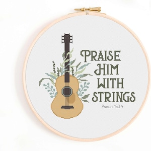 May include: Cross stitch pattern featuring a guitar with green leaves and the text "Praise Him With Strings Psalm 150:4".