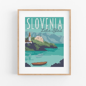 May include: A vintage-style travel poster featuring a scenic view of Lake Bled in Slovenia. The poster has a blue and green color scheme and features a small church on an island in the lake, surrounded by mountains. The text "Slovenia Lake Bled" is printed in white on a blue background.
