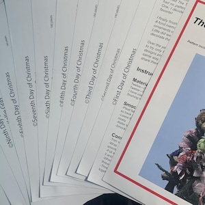 May include: A stack of printed paper patterns for Christmas ornaments, with the title "The Twelve Days of Christmas" by Kellie Gray. The patterns are fanned out, with a close-up of the cover showing a decorated tree.