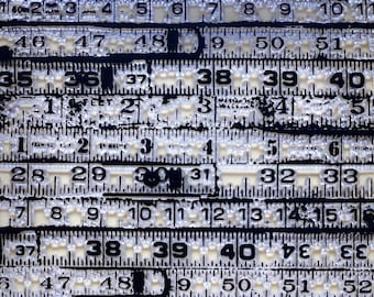May include: A close-up of a black and white measuring tape with numbers from 1 to 60. The tape is worn and has a distressed look.