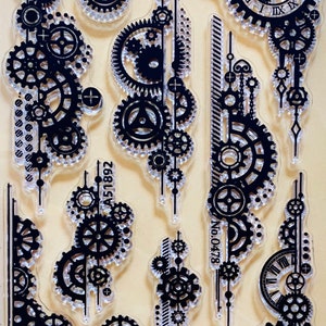 May include: A clear sheet of transparent stamps with black ink designs of gears, clock faces, and other steampunk-inspired elements. The stamps are labeled with the numbers "No. 0478" and "A51892".