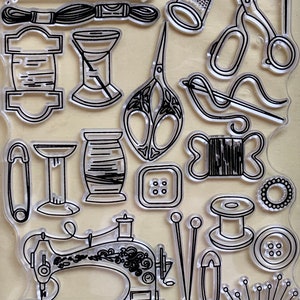 May include: A set of clear stamps featuring sewing and crafting tools, including a sewing machine, spools of thread, scissors, thimbles, needles, buttons, and a pincushion.