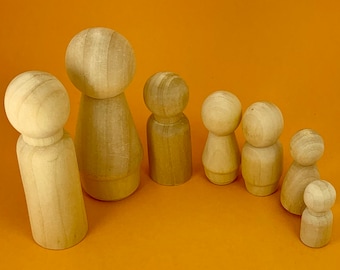 May include: A set of seven wooden peg dolls in various sizes, ranging from small to large. The dolls are all made of natural wood and have a smooth, unfinished surface. They are arranged in a row from largest to smallest, with the largest doll at the left and the smallest doll at the right.