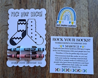 May include: A coloring page with a pair of socks and the text "rock your socks!" and "World Down Syndrome Day" with crayons. A rainbow sticker with the text "Down Syndrome Awareness" is in the upper right corner.