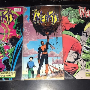 May include: A collection of vintage comic books featuring the title "The Weird." The covers display vibrant illustrations of superheroes and villains in action, with bold colors and dynamic compositions. The text includes "Who is... What is..." and "And why are America's greatest heroes helpless before him?"