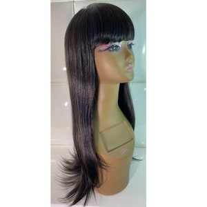 May include: A long, black wig with straight bangs. The wig is on a mannequin head.