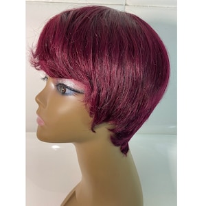 May include: A short, burgundy wig with bangs on a mannequin head.