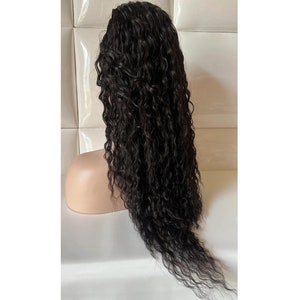 May include: A long, black, curly human hair wig on a mannequin head.