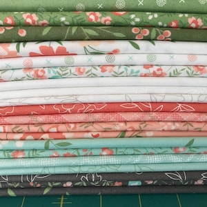 May include: A stack of folded fabric in various floral patterns and colors. The fabrics include shades of green, white, coral, and gray. The floral designs feature flowers and leaves, suitable for quilting or sewing projects.
