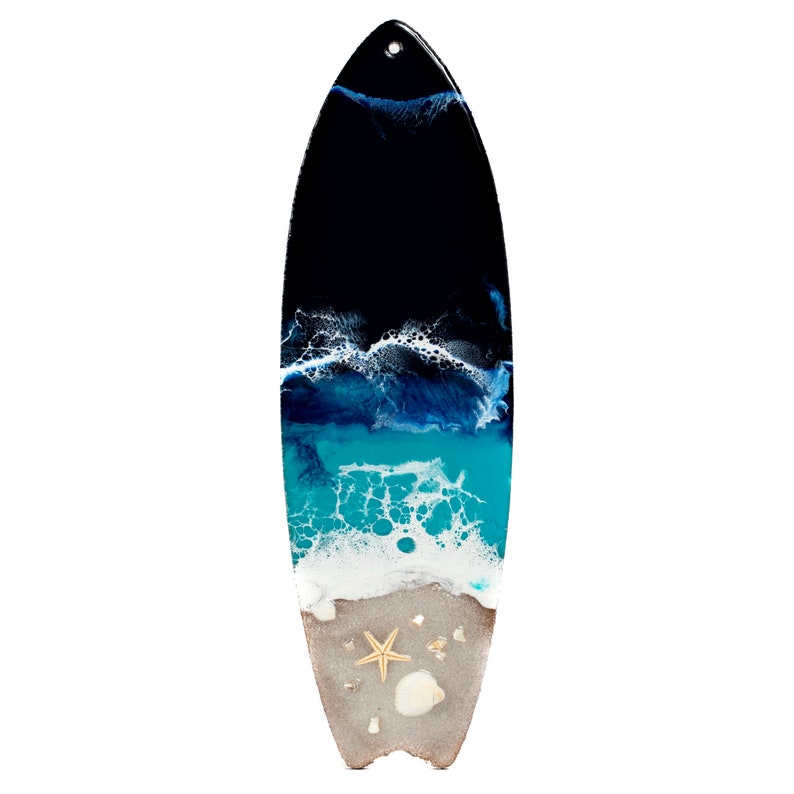 May include: A surfboard painted with an abstract ocean scene. The surfboard is painted with shades of blue, white, and black to represent the ocean, waves, and sky. The bottom of the surfboard is painted to look like sand with a starfish and seashells.