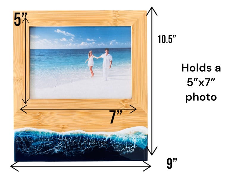 May include: A bamboo picture frame with a blue and white resin ocean wave base. The frame holds a 5" x 7" photo and measures 7" wide by 9" tall and 10.5" high.