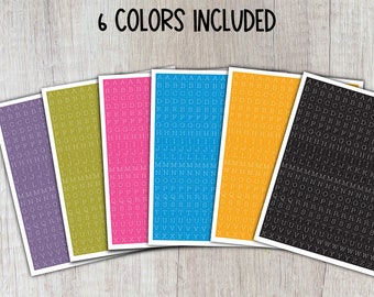 May include: Six sheets of alphabet stickers in different colors: purple, green, pink, blue, yellow, and black. Each sheet has the alphabet repeated in rows.