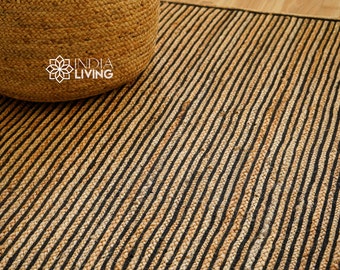 May include: A natural fiber rug with black and natural colored stripes. The rug is made of jute and has a woven texture.