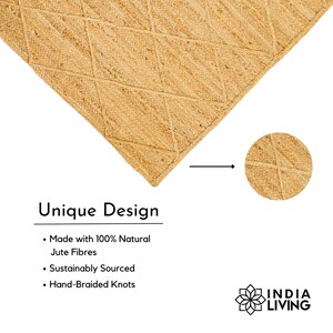 May include: A close-up of a natural jute rug with a diamond pattern. The rug is made with 100% natural jute fibers, sustainably sourced and hand-braided. The text "Unique Design" is written below the rug, along with a list of features: "Made with 100% Natural Jute Fibres", "Sustainably Sourced", and "Hand-Braided Knots". The text "INDIA LIVING" is written in a stylized font below the rug.