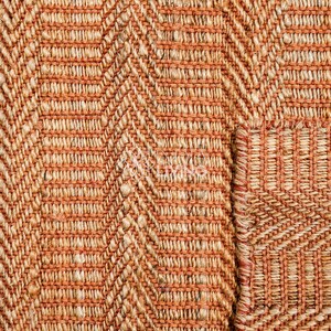 May include: A woven rug featuring a prominent herringbone pattern in alternating shades of burnt orange and natural beige. The texture is coarse and fibrous, with a visible grid-like weave structure throughout the surface of the material.