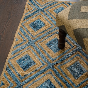 May include: A blue and tan woven rug with a geometric pattern. The rug is made of jute and denim.